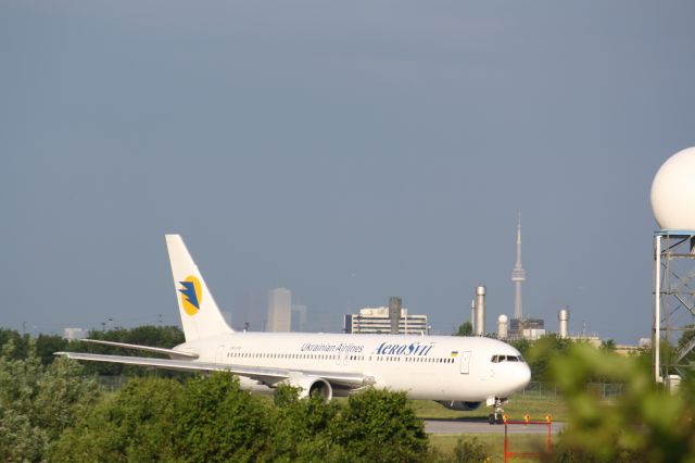 BOEING 767-300 (UR-VVO) - In the background,Torontos famous landmark,the C.N Tower,Taken at Lester B. Pearson Airport,CYYZ/YYZ