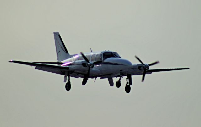 Piper Navajo (N727SC) - Piper N727SC on short final for 4R at Chicago Midway. Note the nose gear not fully extended, moments later the gear collapsed upon landing on runway 4R.