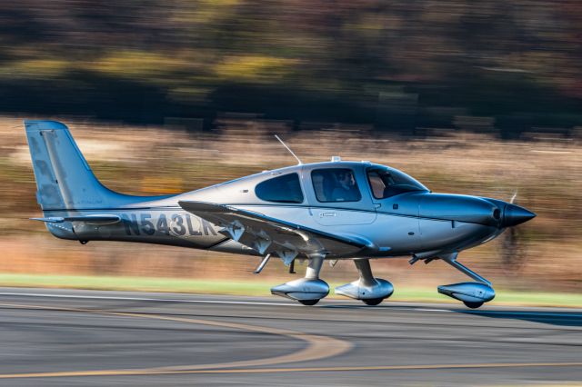 Cirrus SR-22 (N543LK) - Panning shot during a late fall afternoon of Cirrus SR22 N543LK just taking off at KLOM (Wings Field).br /br /1/60 sec. f/18 500 mm ISO 500