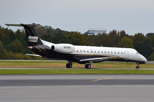 Embraer ERJ-145 (N508RH) - HENDRICK MOTORSPORTS LLC taxiing at KJQF with the Charlotte Motor Speedway in the background - 10/25/18