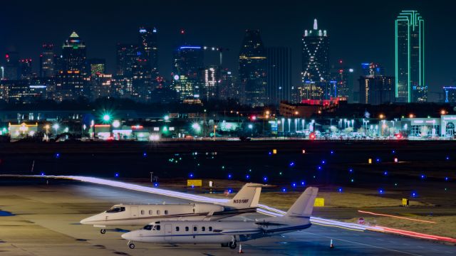 Learjet 55 (N551MF) - Jet Aviation ramp with downtown Dallas in the background