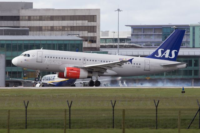 Airbus A319 (OY-KBR) - SAS541 is a flight number thats been used for several decades on the Copenhagen-Manchester flight.  Here OY-KBR leaves some tyre smoke on landing.