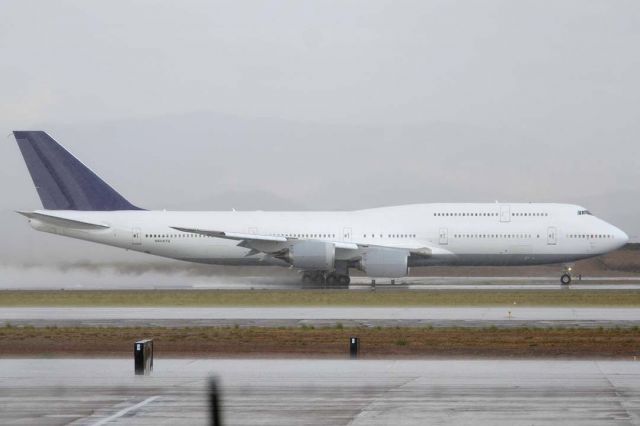 BOEING 747-8 (N6067U) - 747-830 International N6067U kicks up spray as it starts rolling on a mid-field departure from Runway 30 Center into a thunderstorm.