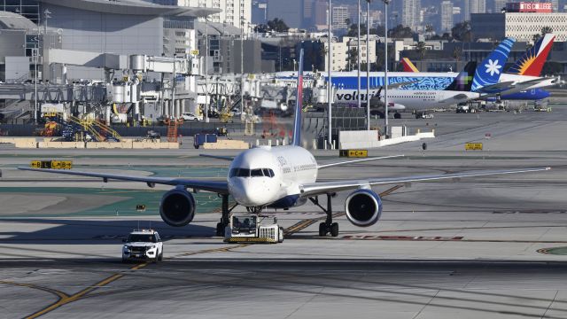 Boeing 757-200 (N666DN) - Getting towed across 25L via taxiway Lima at LAX