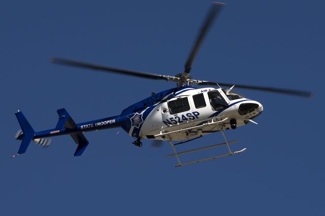 Bell 407 (N524SP) - "Trooper 4" landing taxiway Alpha. -January 2014
