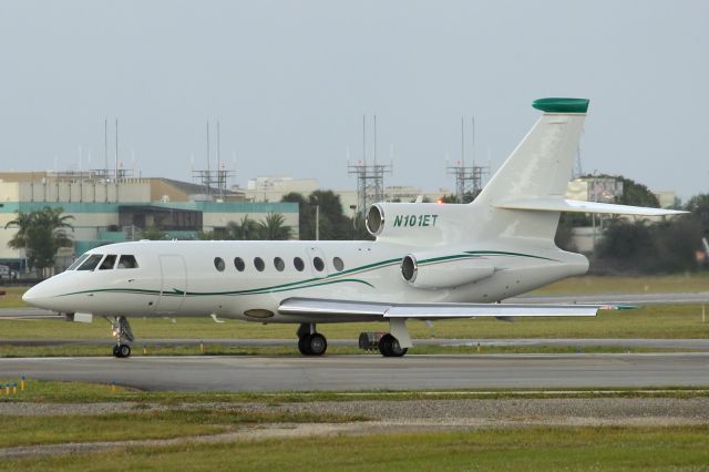 Dassault Falcon 50 (N101ET) - Taxiing for takeoff from runway 8. Taken from the observation area, just before the rain. 11/8/13, the day before my birthday!