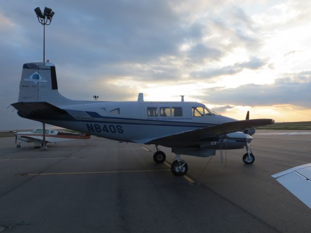 Beechcraft Queen Air (65) (N840S) - After flying over the North Pole, N840S sits watching traffic depart from KDEN (Main terminal is just off the right wing tip).