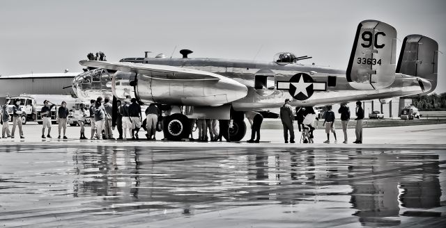 — — - B-25 Gerald R Ford International Airport in Grand Rapids,MI with West Michigan Aviation Academy high school students walking around the plane