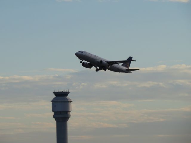 Airbus A320 (N408UA) - N408UA departs KCLE passing the new tower on her way to KORD operating as UAL1134.