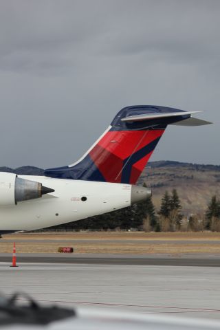 Canadair Regional Jet CRJ-700 (N713EV) - N713EV at Butte after landing from KSLC as SKYWEST 4312. Engines just turned off, with the APU on with the Berkeley Pit behind it.br /br /Taken 17:04, November 2, 2024 with a Canon EOS T2i and 70-300mm (115mm, 1/200, ƒ5, ISO 100)