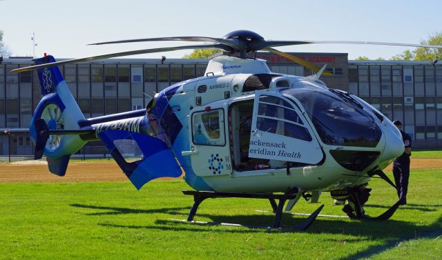 Eurocopter EC-635 (N732HM) - RAHWAY, NEW JERSEY, USA-MAY 09, 2022: A medical transportation helicopter is seen on the ground in front of the Rahway Middle School preparing for a flight from Robert Wood Johnson Hospital-Rahway, N.J. to Robert Wood Johnson Hospital-New Brunswick, N.J. When transporting to or from RWJ-Rahway, the helicopter will use the school's ball field as a landing zone because the hospital lacks a permanent fixed heli-pad. As such, it uses the nearest fixed heli-pad as its landing code, Merck & Company's 7NJ8, located about a mile away.