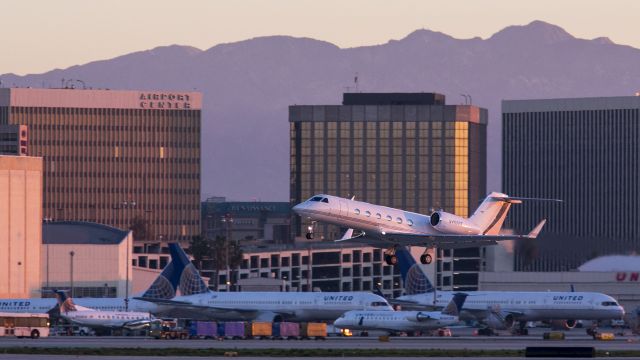 Gulfstream Aerospace Gulfstream IV (N450EE) - This pretty Gulfstream has broken into the morning sunshine at LAX, Los Angeles, California USA. How would you prefer traveling to work, by G-IV or one of the other choices seen below it? 