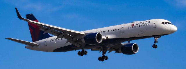 Boeing 757-200 (N690DL) - Delta 757 landing. Taken from Airport loop drive cul-de-sac next to runway 20R.