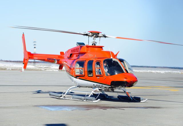 Embraer Phenom 300 (C-GXNH) - This Bell 407 GX landed on the ramp near the Gander domestic terminal for passenger transfer.  