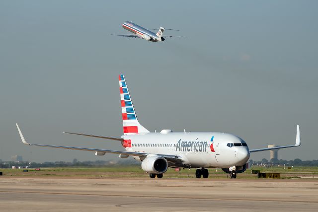 McDonnell Douglas MD-83 (N984TW) - September 4, 2019 - End of an era as the final American Airlines MD-80 revenue flight, AA80 departs in the background, marking the end of an era at the airline after 36 years. Fittingly, it's replacement taxies by in the foreground.