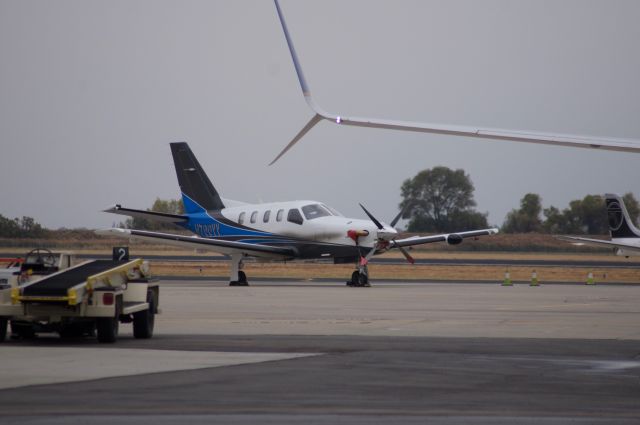 Socata TBM-700 (N700VV) - On the ramp waiting for departure. Wing with split winglets is United 737-8 (N75623) br /Best viewed in full!