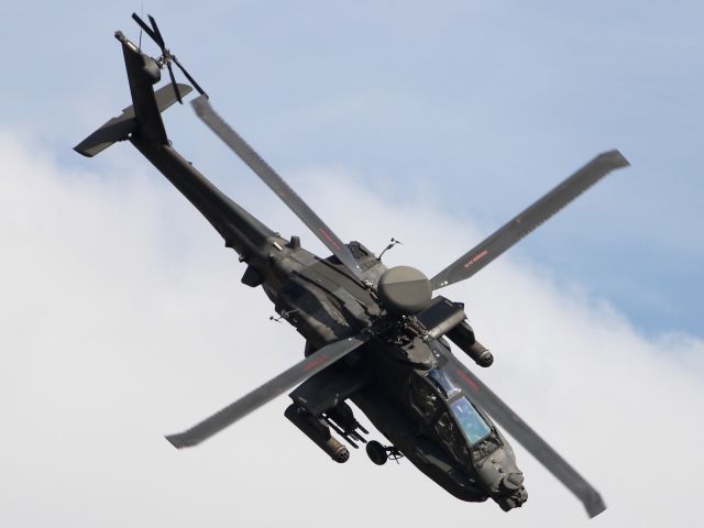 — — - Apache Attack Helicopter runs through an impressive aerial display at Duxford Air Museum.