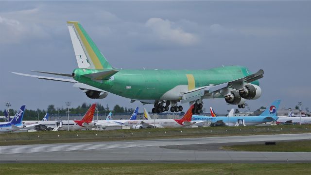 BOEING 747-8 (B-LJH) - BOE558 (LN:1457) nearing touchdown to runway 16R and completion of its maiden flight on 6/14/12. Still in primer it will soon be painted in the livery of Cathay Pacific (CPA).