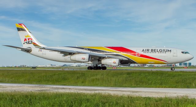 Airbus A340-300 (OO-ABB) - Toronto spotters delighted to see an A340 again at YYZ as British Airways lease this Air Belgium bird while Dreamliner engine issues are sorted. Here she holds short of runway 06L awaiting takeoff clearance for the journey back to Hesthrow