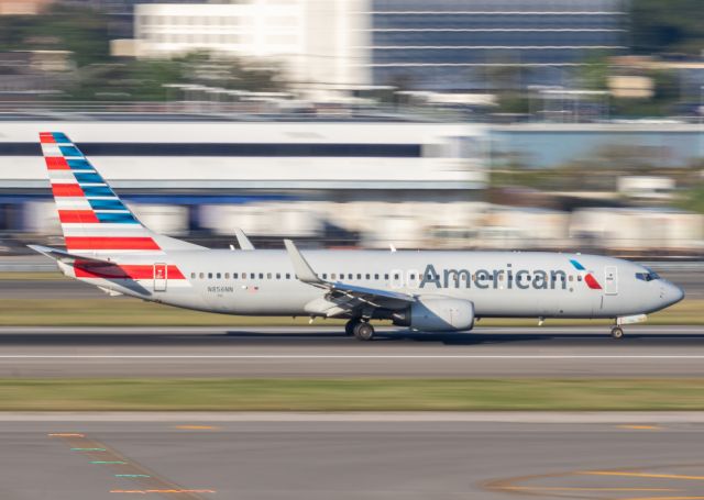 Boeing 737-800 (N856NN) - An American Airlines Boeing 737-800 slowing down on runway 13L. I'm experimenting with a low shutter speed to achieve the background.