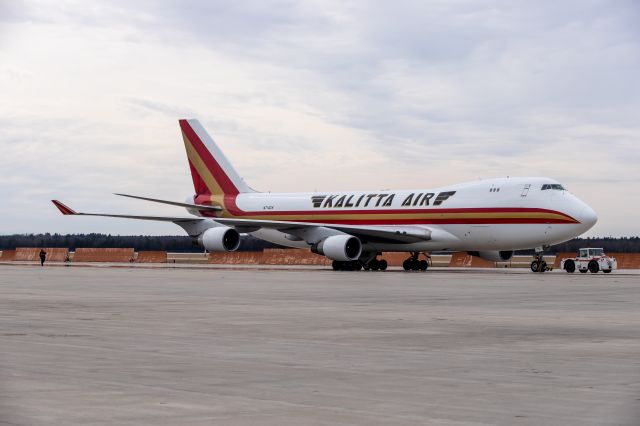 Boeing 747-400 (N710CK) - Kalitta Air 747-400 being tugged into parking at Hangar 8 after an engine run.