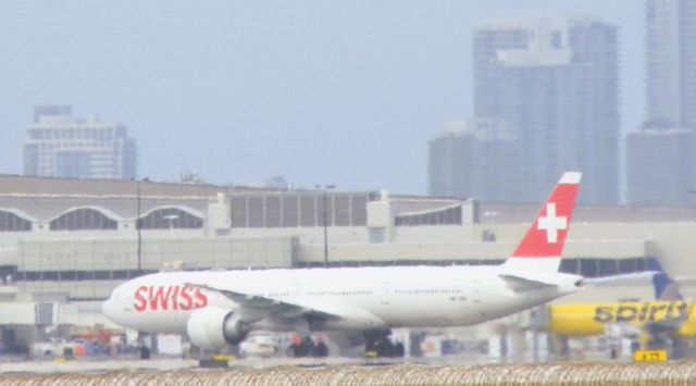 BOEING 777-300ER (HB-JNH) - A Swiss B777-300ER"Holding short after Landing from Zurich,Kloten(ZRH,LSZH) Making way for the terminal!!