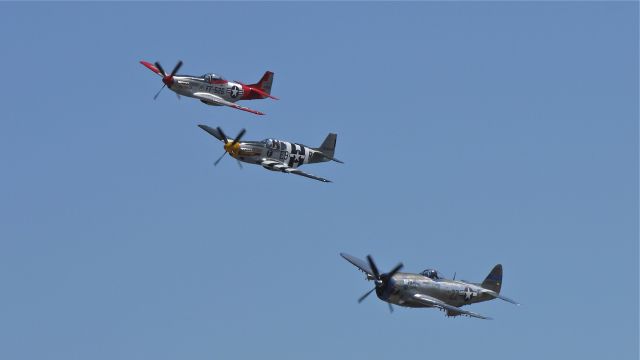 North American P-51 Mustang (N5087F) - A P51D (VAL-HALLA), P51B (IMPATIENT VIRGIN?) and P47D (TALLAHASSEE LASSIE) make a low pass at Vintage Aircraft Weekend. Photographed 9/3/11.