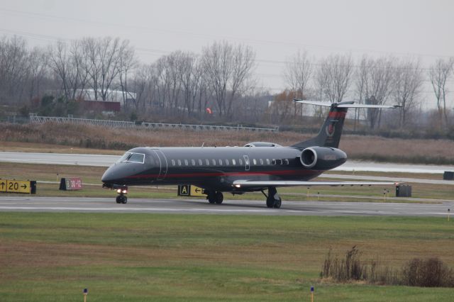 Embraer ERJ-145 (N138DE) - Embraer ERJ 145 at Gary Regional Airport on Taxiway "alpha".