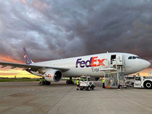 Airbus A300F4-600 (N749FD) - Wheel chocks being pulled in the hope of a smooth departure before the summer storm arrives. 