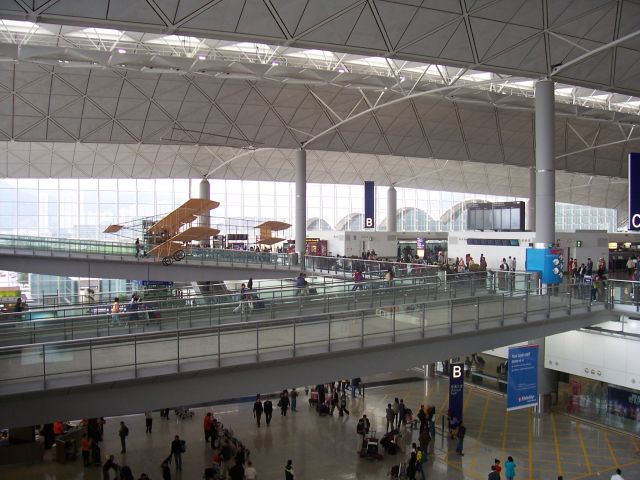 — — - Hong Kong International Airport  Static display, a copy of the Wright Brothers flier dwarfed  in the departures hall - the pedestrian ramps are longer than its first flight    This airport has to be the largest and most functional   I have ever visited and is definately a fave of mine