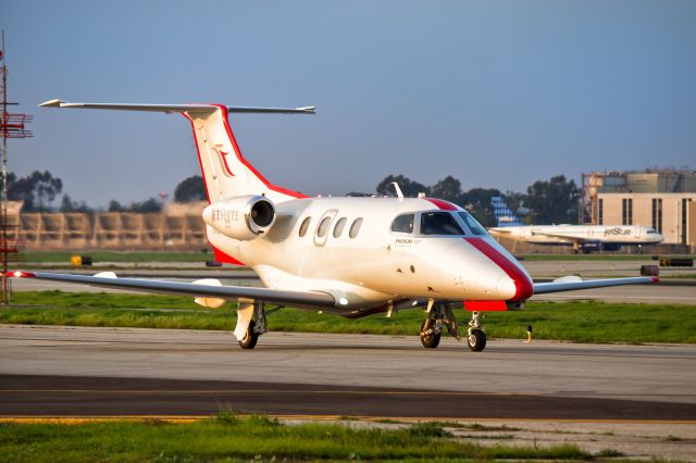 Embraer Phenom 100 (N585JS) - JetSuite Embraer Phenom 100 taxiing out to the main at KLGB for a sunset departure.