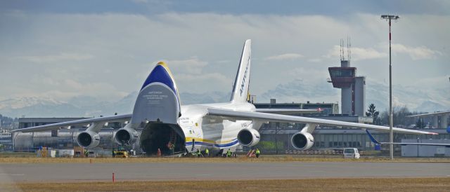 Antonov An-12 (UR-82007) - Ukrainian AN-124 in front of the Swiss alps. Loading a spare engine for the Swiss B777 forced to land in Iqaluit and waiting for it.