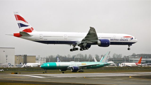 BOEING 777-300 (G-STBI) - BOE75 on final to Rwy 16R to complete a flight test on 1/22/14. (LN:1171 cn 43702).  BOE336 #VQ-BQC for AFL sits on the taxiway waiting for the ceiling to lift so it can depart on its maiden flight. (LN:1175 cn 41688).