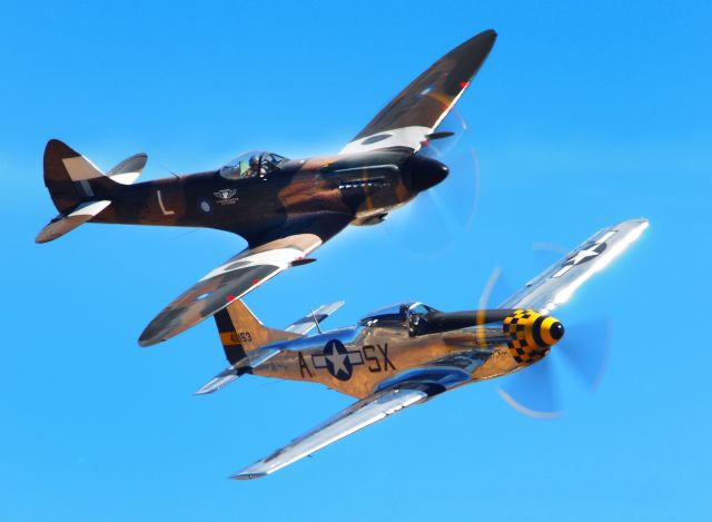 — — - British Spitfire and North American P-51D Mustang fly in formation during Mather field's, Capitol Air Show 2012 in Rancho Cordova, CA.