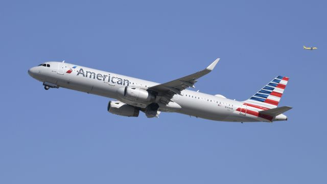 Airbus A321 (N144AN) - Departing LAX on 25R with a Spirit A320 in the background on the downwind for 24R