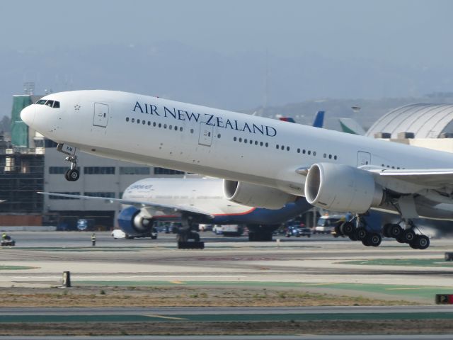 BOEING 777-300ER (ZK-OKM) - Air New Zealand blasts out of LAX as Aeroflot pulls into the gate after a long flight. July 2015