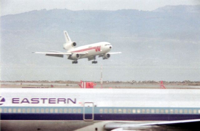 Lockheed L-1011 TriStar (N318EA) - Western Airlines DC-10 landing at SFO - with an Eastern L-1011 passing to the gate