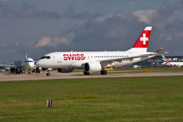 Bombardier CS100 (HB-JBA) - Now in regular service to Manchester, SWR391 departs for Zurich with a variety of aircraft waiting their turn.