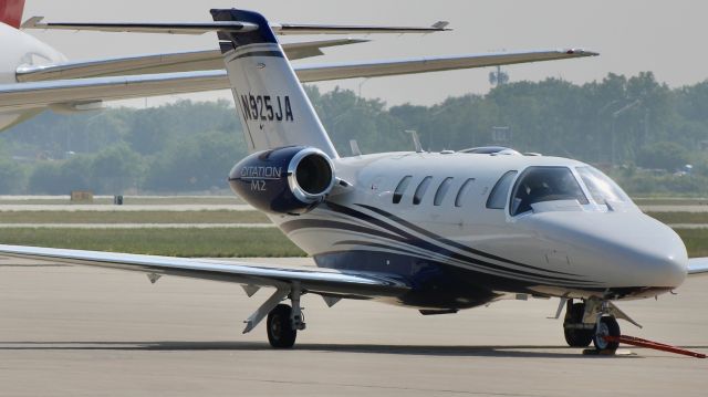 Cessna Citation M2 (N925JA) - A nice little M2 on the Gary Jet Center ramp with the New England Patriots 767 in the background. br /br /N925JA. 2017 Cessna 525 Citation M2. Private. KGYY. 6/20/23. 