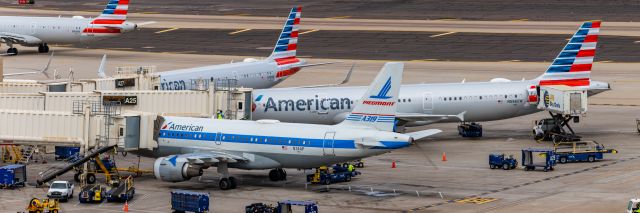 Airbus A319 (N744P) - An American Airlines A319 in Piedmont retro livery parked at PHX on 2/13/23, the busiest day in PHX history, during the Super Bowl rush. Taken with a Canon R7 and Canon EF 100-400 II L lens.