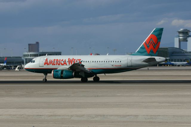 Airbus A319 (N830AW) - KLAS - April 2006 America West landing 25L with the D terminal tower in the right background.
