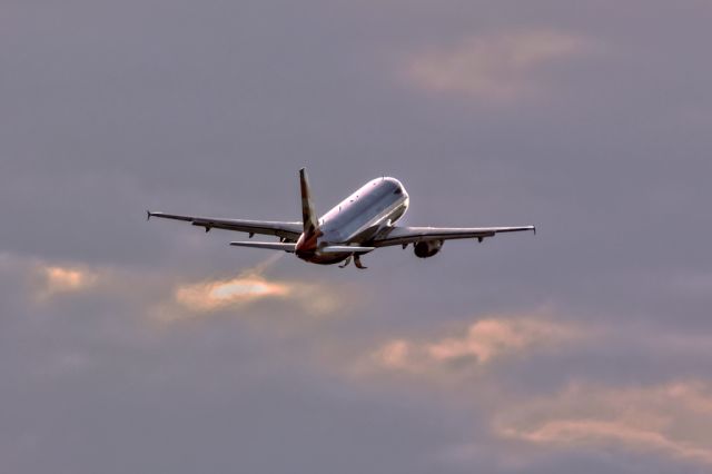 Airbus A320 (G-EUYC) - Dramatic lights in cloudy sky.