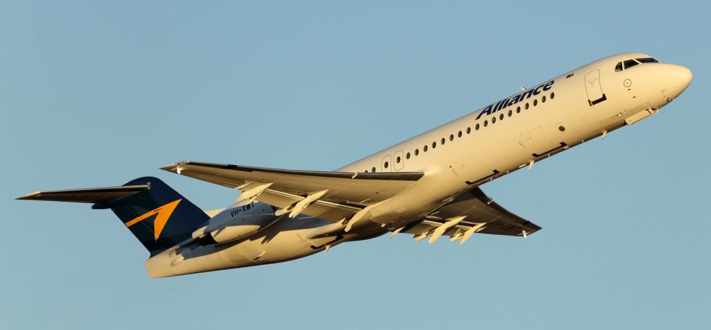— — - Alliance F100 early morning departure from runway 01 at YBTL.