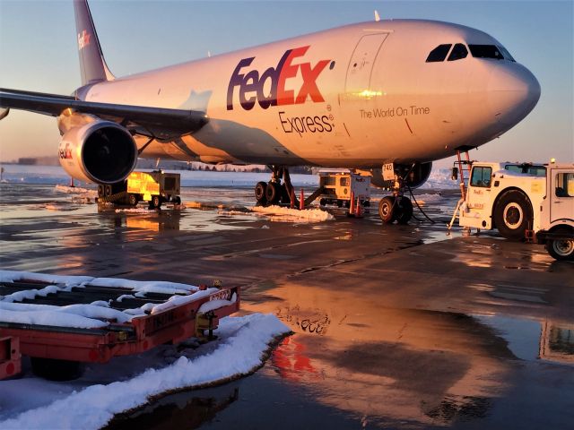 Airbus A300F4-600 (N671FE) - A cockpit mirror image seen in the melted snow and deicing solution.br /br /A late winter day in Appleton.