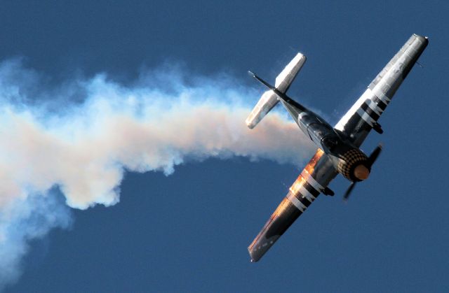 — — - Immersed in his own smoke during airshow routine - I enjoyed the effect of the sun behind the plane and smoke and the shadows it created