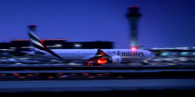 BOEING 777-300ER (A6-ECF) - UAE/EK236 took off on runway 10L on 07/12/2015. Since I used very high iso to capture such fast moment, the picture is not of high quality. But the color and motion are amazing.