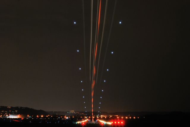 — — - 30 second exposure of twin-engine turboprop landing from behind me on Runway 3R at Lunken Airport, Cincinnati, Ohio.