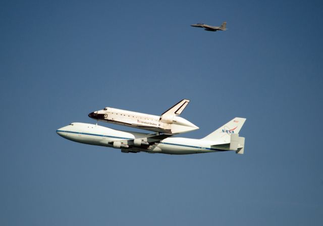 Boeing 747-200 (N905NA) - On September 21, 2012 was in San Francisco for the Endeavor tour of California. Closeup shot with F-15 chase plane in the background.