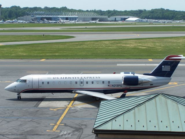 Canadair Regional Jet CRJ-200 (N213PS) - N213PS prepares to taxi away from the ramp at Westchester County June 8th 2011