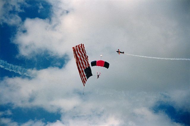 — — - Opening parachute jumper at an Air Power Air Show in KOKC